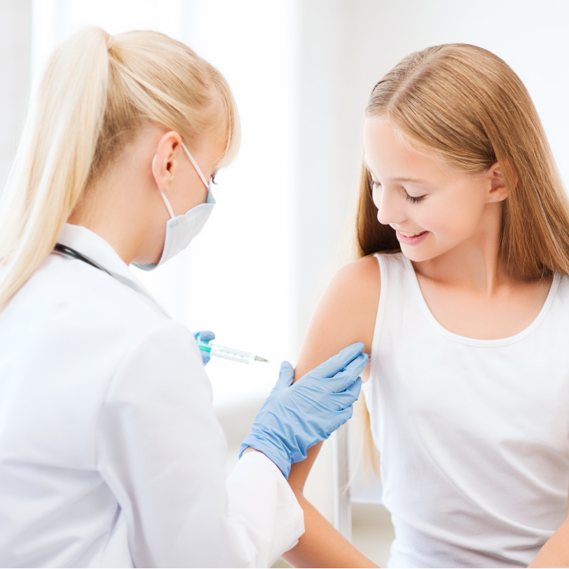 Doctor vaccinating a teenage girl